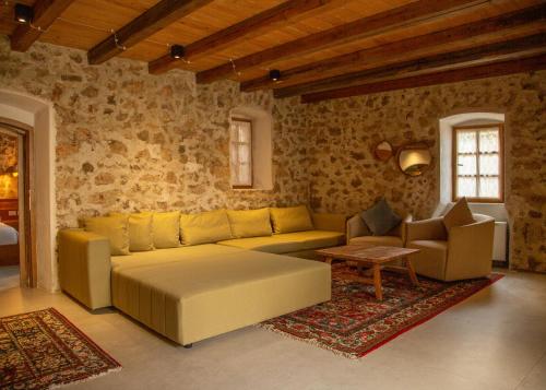 a living room with a couch and a table at Zoe Hora in Dhërmi