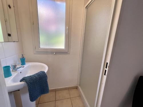 a bathroom with a sink and a window at Apartment La Foret in Grimaud