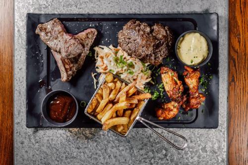 a plate of food with meat and french fries and sauce at Bellevue in Les Gets