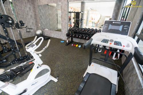 a gym with two machines and a treadmill at Hoàng Gia Hotel Tuy Hoà in Tuy Hoa