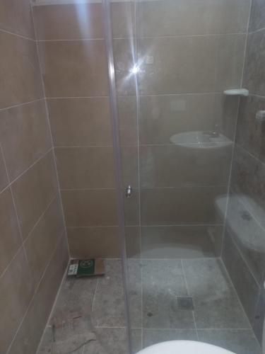 a bathroom with a shower with a toilet and a sink at caribepremiumvalledupar in Valledupar