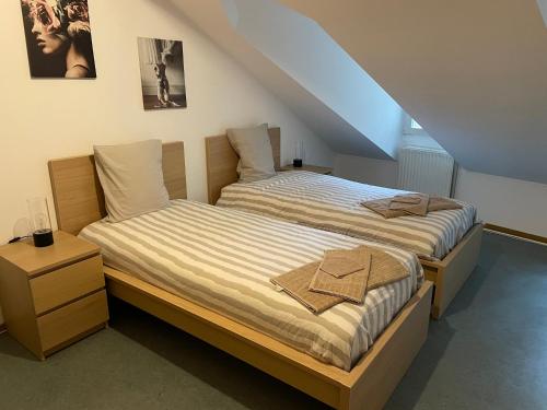 a bedroom with two beds and a staircase at Superbe logement à proximité du centre et du Kirchberg in Luxembourg