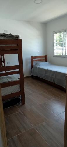 a bedroom with two bunk beds and a wooden floor at Alquiler temporario zona sur MDQ in Mar del Plata