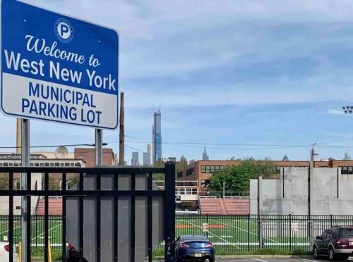 a sign that reads welcome to the west new york municipal parking lot at Cozy 2 BR suite, 10 min to NYC &Times Sq in West New York