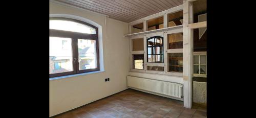 an empty room with a large window and a door at Ferienwohnung Dillenburg Jung in Dillenburg