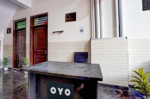 a table in front of a building with an ovy sign on it at OYO Hotel Vedant in Noida