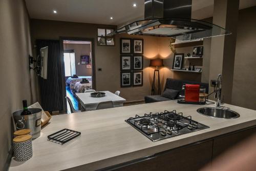 a kitchen with a stove top oven next to a living room at Casa Via Po in Turin