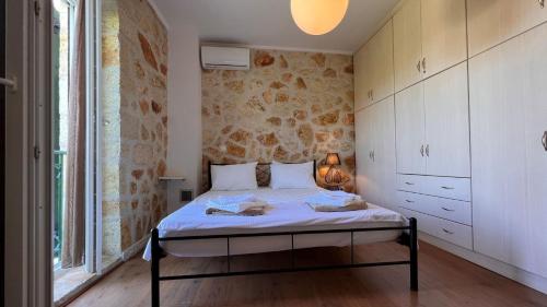 a bedroom with a bed in a room at Splendid Gouvia Villa 3 Bedrooms Villa Yiarios Private Playground in Pouládes