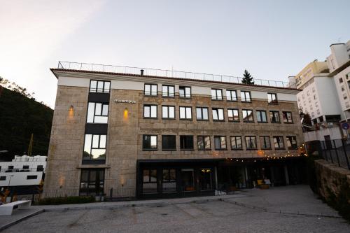 a large brick building with a lot of windows at micampus Covilhã in Covilhã