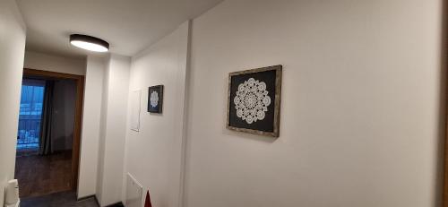 a hallway with two pictures on a white wall at Agroturystyka Koronkowe Zacisze in Koniaków
