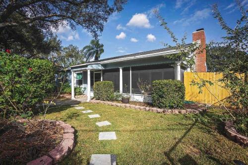 a house with a garden in front of it at Heated Pool in Private House w/ Fire Pit in Seffner