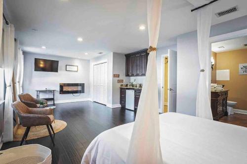 a bedroom with a bed and a living room at Heated Pool in Private House w/ Fire Pit in Seffner