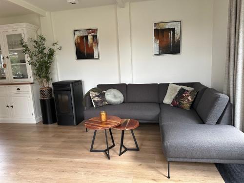 a living room with a couch and a table at De Lijster in Bergen