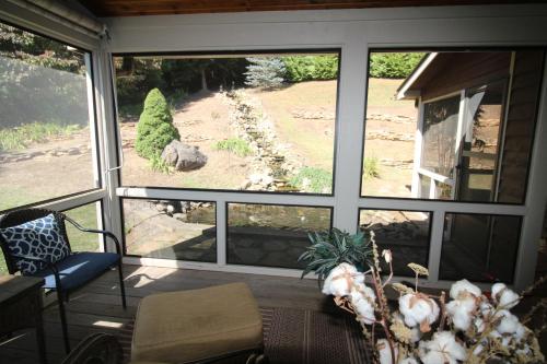 a screened in porch with a view of a yard at The Ponderosa in Jefferson