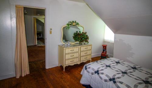 a bedroom with a dresser with a mirror on it at Country Classic in Crumpler
