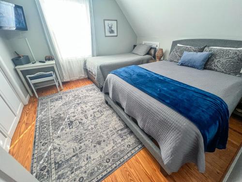 a small bedroom with a bed and a rug at Bluff Mountain Retreat in West Jefferson