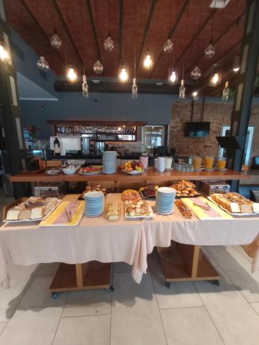 a table with many different types of food on it at Hotel Plaza in Colón