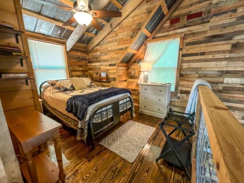 a bedroom with a bed in a wooden cabin at Reddies River Retreat - New Rental 2023 in Millers Creek