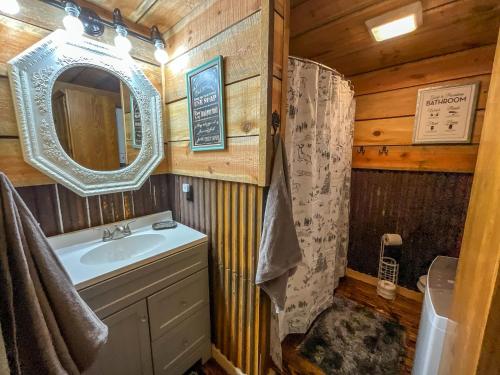 a bathroom with a sink and a mirror at Reddies River Retreat - New Rental 2023 in Millers Creek