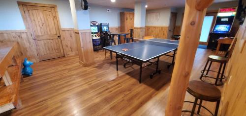 a ping pong table in the middle of a room at El Cabitan in West Jefferson