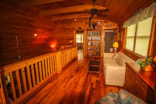 a living room of a log cabin with a couch at Rest Assured in West Jefferson