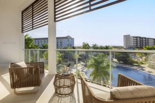 a balcony with a view of a pool at Royalton Hideaway Blue Waters, An Autograph Collection All-Inclusive Resort - Adults Only in Falmouth