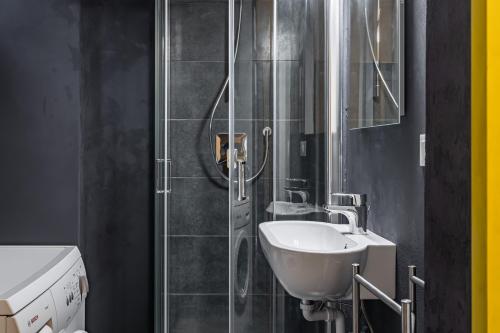 uma casa de banho com um lavatório e um chuveiro em Relais Mangano - Apartment - by HOST4U em Brescia