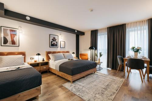 a hotel room with two beds and a desk at ORSO Rooms & Apartments LoftAffair Collection in Warsaw