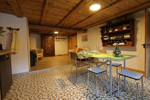 a kitchen and dining room with a table and chairs at Emmental Ferien in Langnau im Emmental