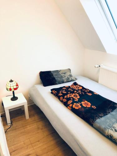 a small bedroom with a bed and a table at Sweet vacation in Harrislee