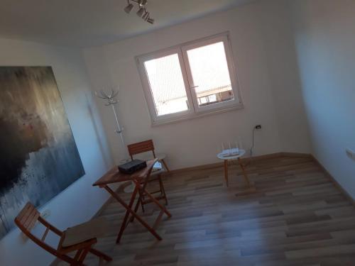 a room with two chairs and a table and a window at Lepa Dolenjska in Uršna Sela