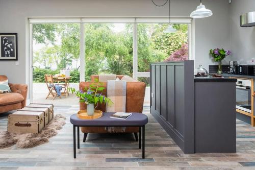 a kitchen and living room with a table in a room at Garden Rooms @ Drumagosker Rural Retreats in Ardmore