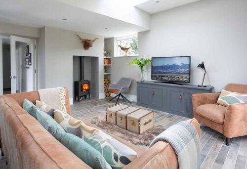 a living room with a couch and a tv at Garden Rooms @ Drumagosker Rural Retreats in Ardmore