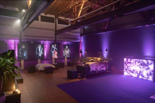 a room with two beds and purple lighting at Indoor Camping Helsinki in Helsinki