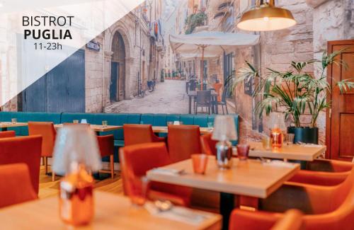 a restaurant with tables and chairs and a mural at Plaza Prague Hotel - Czech Leading Hotels in Prague