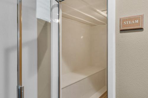 a walk in closet with a glass door at Dunes of Seagrove A104 in Santa Rosa Beach