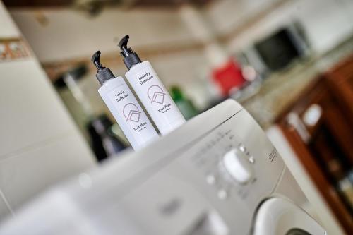 two bottles of wii remotes sitting on top of a washing machine at YourPlace Rabat Agdal 1 - Cozy Residence in Rabat