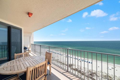 a balcony with a table and chairs and the ocean at Phoenix X 1203 in Perdido Key