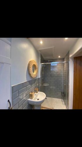 a bathroom with a sink and a shower at Barn Cottage in Youlgreave