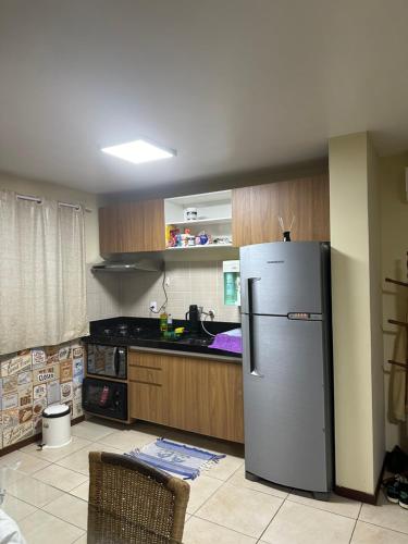 a kitchen with a stainless steel refrigerator in it at Solar pipa duplex lua cheia in Pipa
