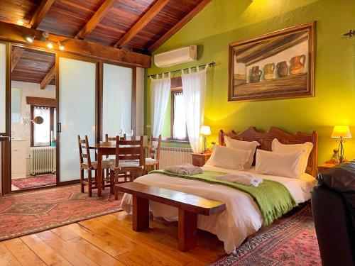 a bedroom with a bed and a dining room with a table at Hotel Peruskenea in Jaunsaras