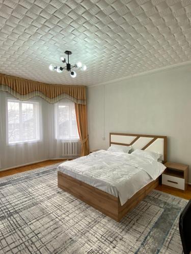 a bedroom with a bed and a ceiling at My Hostel in Osh