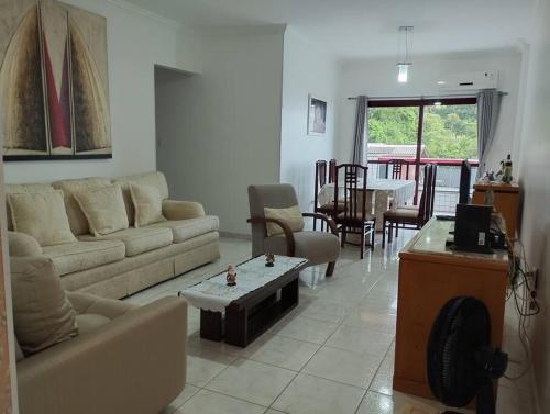 a living room with a couch and a table at Apartamento na Frente da Praia in Itanhaém