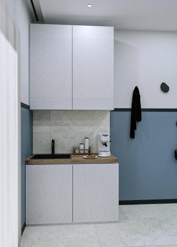 a kitchen with white cabinets and a counter top at Casa di Cornaro in Sitia