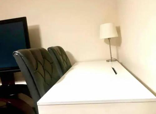 a room with a desk and a chair with a lamp at Ac lounge 115 1-Bed Apartment in Rochford in Rochford
