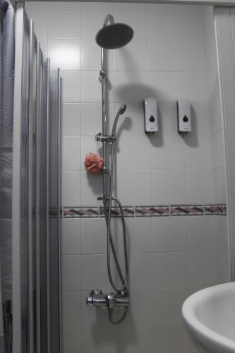 a shower with a shower head in a bathroom at Vistas al Mar Mediterraneo in Melicena
