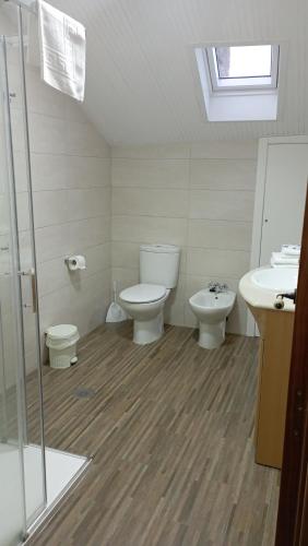 a bathroom with a toilet and a sink at Casa Torre Vella in Bueu