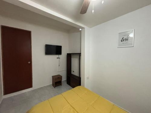 a bedroom with a bed and a flat screen tv at Hermosa Hab,Internet,Centrico, Wi-Fi in Xalapa