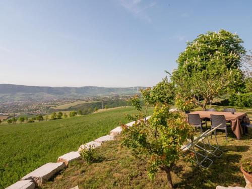 a table and chairs sitting on top of a field at Appartement vue panoramique campagne Pouncho 2 pers in Millau