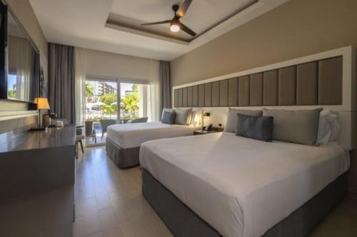 a bedroom with two beds in a hotel room at Hideaway at Royalton Blue Waters, An Autograph Collection all-Inclusive Resort - Adults Only in Falmouth
